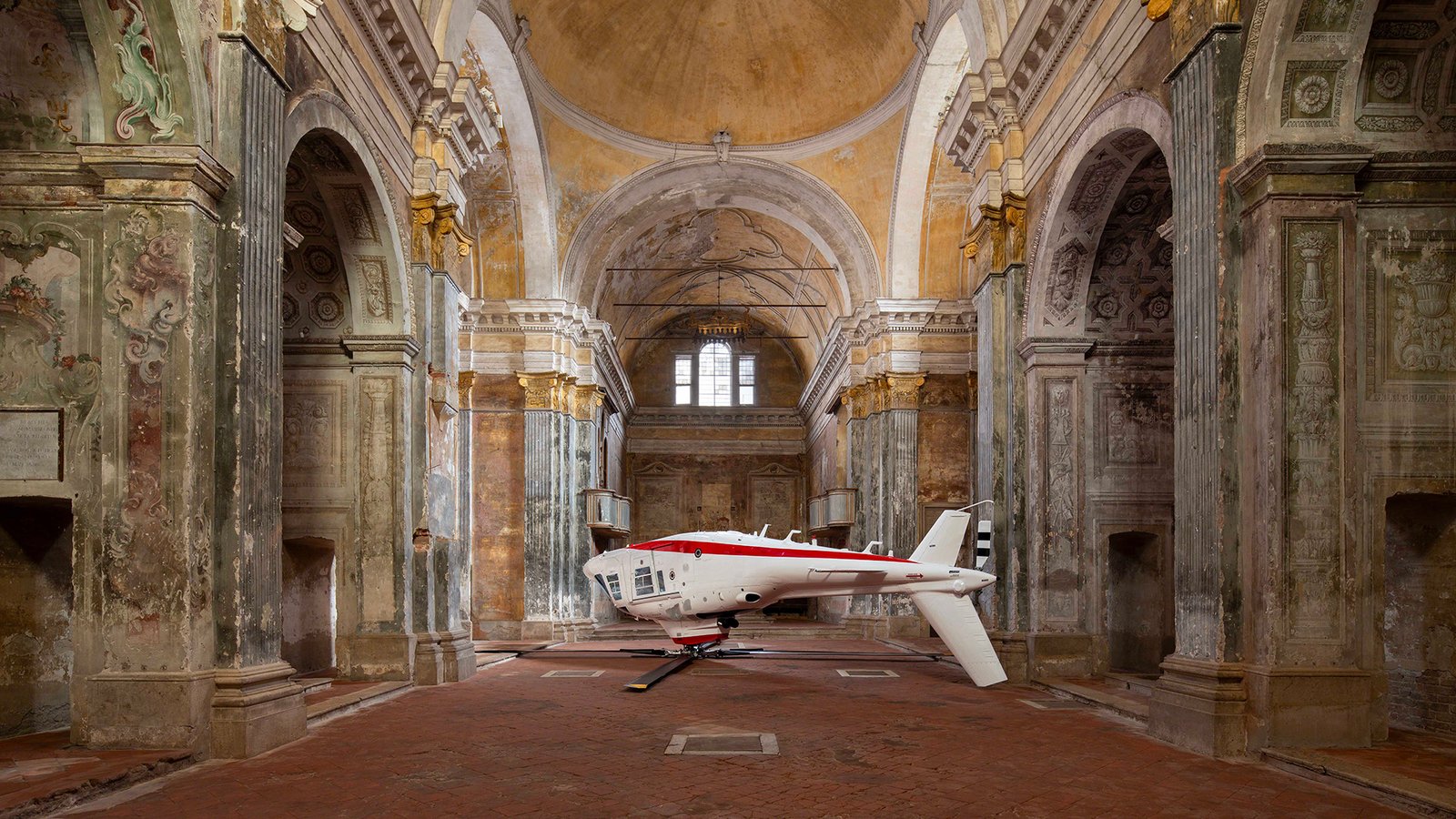 Paola Pivi and the upside-down helicopter that defies reality in the former church of San Carlo in Cremona cover
